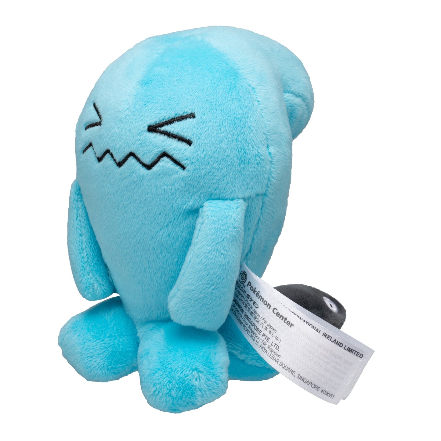 Palm-sized Wobbuffet Pokémon plush with a bright blue body, black squinting eyes, and a tiny black tail peeking from behind.